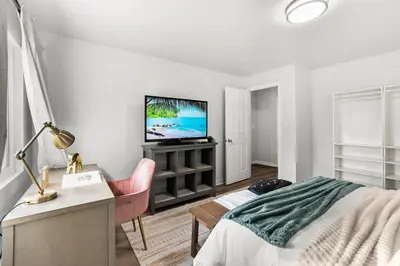 a bedroom with a bed and a tv on a wall at Entire Private Home with 4 Bedrooms 3 Bathrooms, King Bed, Big Yard, Prime Area, Ranch Style, Available Now in La Mesa