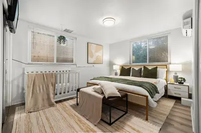 a bedroom with a large bed and two windows at Entire Private Home with 4 Bedrooms 3 Bathrooms, King Bed, Big Yard, Prime Area, Ranch Style, Available Now in La Mesa