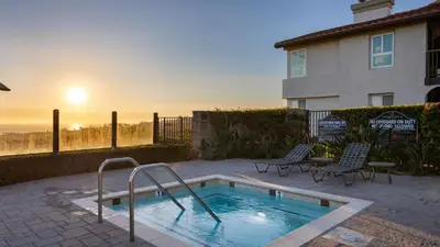 a swimming pool in front of a house at Close to Beach w Patio Resort Amenities The Point at Corniche by AvantStay STR16-0458 in Dana Point