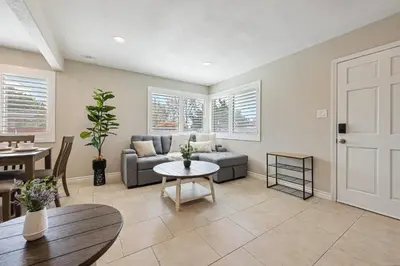 a living room with a couch and a table at 2 Homes in 1 Sleeps 18 10 Min to Zoo and Beach in San Diego