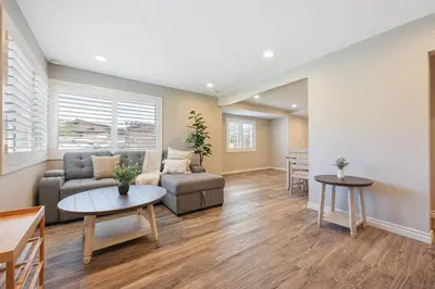 a living room with a couch and a table at 2 Homes in 1 Sleeps 18 10 Min to Zoo and Beach in San Diego