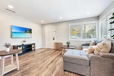 a living room with a couch and a table at 2 Homes in 1 Sleeps 18 10 Min to Zoo and Beach in San Diego