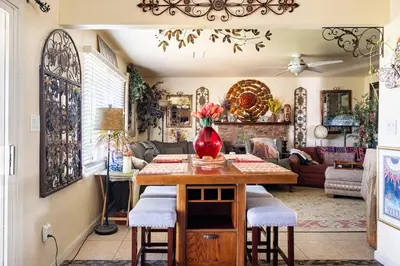 a living room with a table with a vase on it at comfortable home in San Diego Lemon Grove area in Lemon Grove