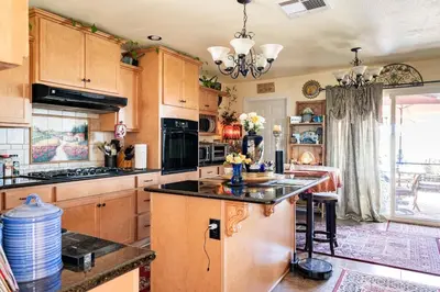 a kitchen with wooden cabinets and a counter top at comfortable home in San Diego Lemon Grove area in Lemon Grove