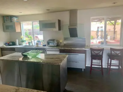 a kitchen with a counter and two chairs in it at Room in Bay Park, San Diego in San Diego