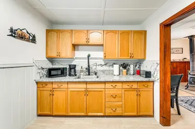 a kitchen with wooden cabinets and a sink at Near Hiking and Mtn Biking Cozy Cabin in Mt Laguna! in Mount Laguna