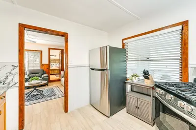 a kitchen with a stainless steel refrigerator and a living room at Near Hiking and Mtn Biking Cozy Cabin in Mt Laguna! in Mount Laguna