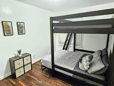 a bedroom with a bunk bed and a night stand at Eagle's Nest - Hot Tub & Stunning Bay View - Walk To Little Italy in San Diego