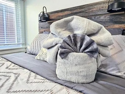 a bed with a blanket on top of it at Eagle's Nest - Hot Tub & Stunning Bay View - Walk To Little Italy in San Diego