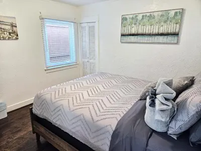 a bedroom with a bed and a window at Eagle's Nest - Hot Tub & Stunning Bay View - Walk To Little Italy in San Diego