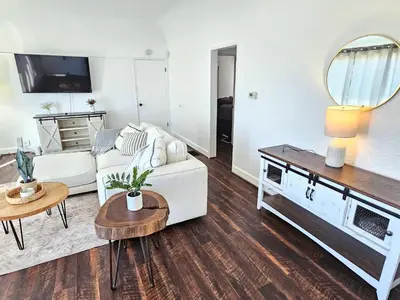 a living room with a white couch and a table at Eagle's Nest - Hot Tub & Stunning Bay View - Walk To Little Italy in San Diego
