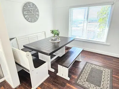 a dining room with a table and chairs and a window at Eagle's Nest - Hot Tub & Stunning Bay View - Walk To Little Italy in San Diego