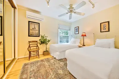 a bedroom with two beds and a fan at Sunny Gardens A Classic La Jolla Beach Home Close to Wind n Sea Beach in San Diego