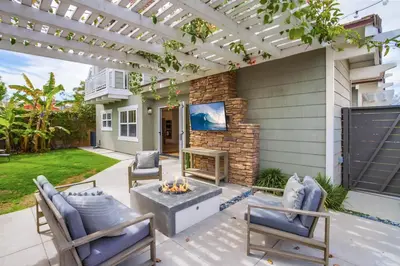 a patio with a fire pit and a pergola at Leucadia Paradise in Encinitas