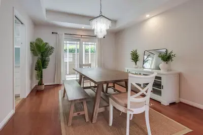 a dining room with a wooden table and chairs at Leucadia Paradise in Encinitas