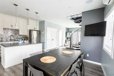 a kitchen with a table and chairs in a room at Sunrise Loft in San Diego