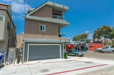 a building with a large garage in front of a street at Sunrise Loft in San Diego