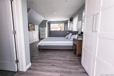 a bedroom with a bed and a desk in it at Sunrise Loft in San Diego