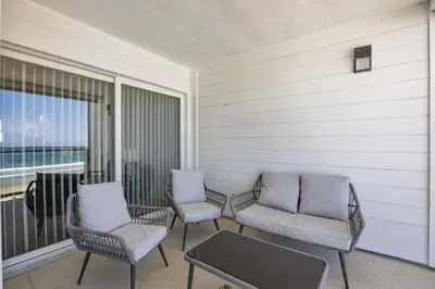 a porch with chairs and a table and a window at Shoreline Hideaway in San Diego