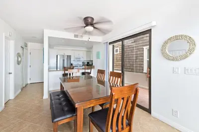 a dining room and kitchen with a table and chairs at Spacious Oceanfront Home Near Newport Pier in Newport Beach