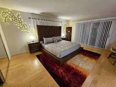 a bedroom with a large bed and a rug at La Jolla Gem with Ocean View - 11 Beds, Hot Tub, Karaoke & Game Den in San Diego