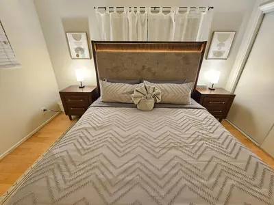 a bedroom with a large bed with a bow on it at La Jolla Gem with Ocean View - 11 Beds, Hot Tub, Karaoke & Game Den in San Diego