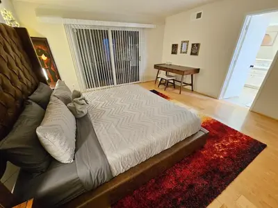 a living room with a couch and a table at La Jolla Gem with Ocean View - 11 Beds, Hot Tub, Karaoke & Game Den in San Diego