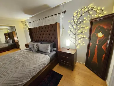 a bedroom with a bed and a painting on the wall at La Jolla Gem with Ocean View - 11 Beds, Hot Tub, Karaoke & Game Den in San Diego