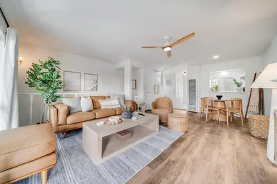a living room with a couch and a table at BoHo Beach House Walk to the Sand in San Diego