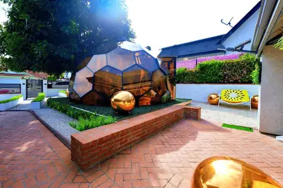 a sculpture of an elephant is sitting in a yard at Casa de Bloom Venue - Your Perfect Event Space in San Diego