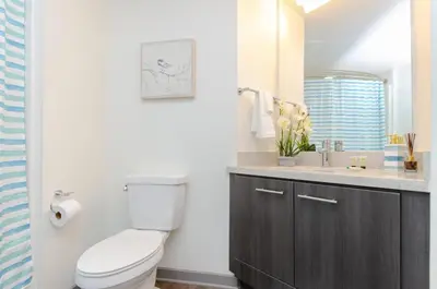 a bathroom with a toilet and a sink at Charming 3 Bedroom Apartment with Pool Near San Diego Convention Center in San Diego