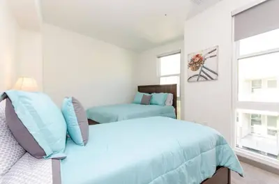 a bedroom with two beds and a window at Charming 3 Bedroom Apartment with Pool Near San Diego Convention Center in San Diego