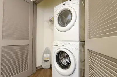 a washer and dryer in a laundry room at Charming 3 Bedroom Apartment with Pool Near San Diego Convention Center in San Diego