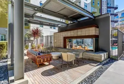 a patio with a table and chairs and a fireplace at Charming 3 Bedroom Apartment with Pool Near San Diego Convention Center in San Diego