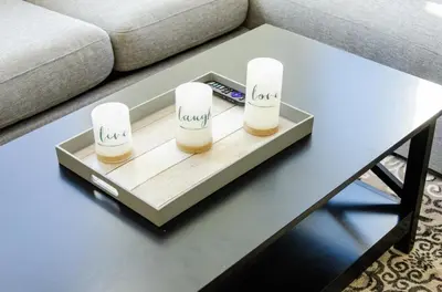 a coffee table with three candles on top of it at Charming 3 Bedroom Apartment with Pool Near San Diego Convention Center in San Diego