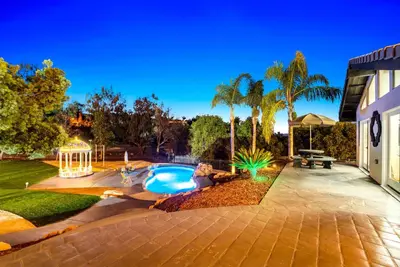 a backyard with a pool and a gazebo at The Grand Vista Getaway in Vista