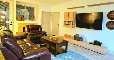 a living room with a leather couch and a table at Wine Country Reserves in Murrieta