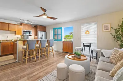 a living room and kitchen with a couch and a table at 2 Bdrm Condo + Parking in Heart of Mission Beach! in San Diego