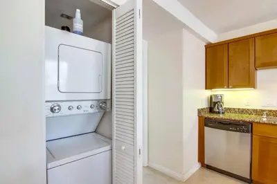 a kitchen with a white refrigerator and a dishwasher at 2 Bdrm Condo + Parking in Heart of Mission Beach! in San Diego