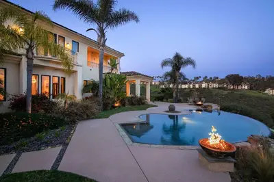 a house with a swimming pool with a fire fountain at 7BR Carlsbad Estate with Pool Firepit & Views in Carlsbad