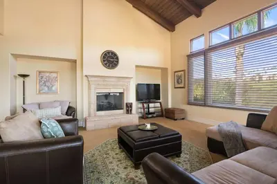 a living room with a couch and a fireplace at 7BR Carlsbad Estate with Pool Firepit & Views in Carlsbad