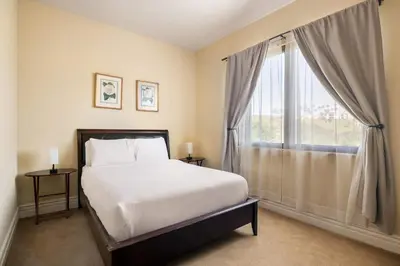 a bedroom with a bed and a large window at 7BR Carlsbad Estate with Pool Firepit & Views in Carlsbad