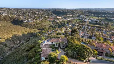 an aerial view of a house on a hill at 7BR Carlsbad Estate with Pool Firepit & Views in Carlsbad