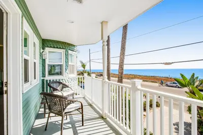 a house with two chairs on a porch overlooking the ocean at F-72 Terramar Cliffs in Carlsbad