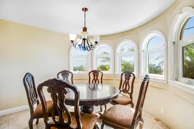 a dining room with a table and chairs and windows at F-73 Terramar Cliffs in Carlsbad