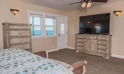 a bedroom with a large television and a dresser at F-73 Terramar Cliffs in Carlsbad