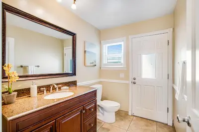 a bathroom with a sink and a toilet and a mirror at F-73 Terramar Cliffs in Carlsbad