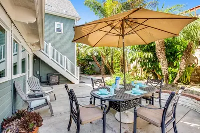 a patio with a table with an umbrella at F-73 Terramar Cliffs in Carlsbad