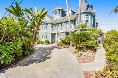 a large blue and white house with palm trees at F-75 Terramar Cliffs in Carlsbad
