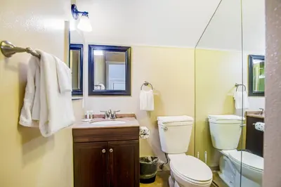 a bathroom with a toilet and a sink and a mirror at F-75 Terramar Cliffs in Carlsbad